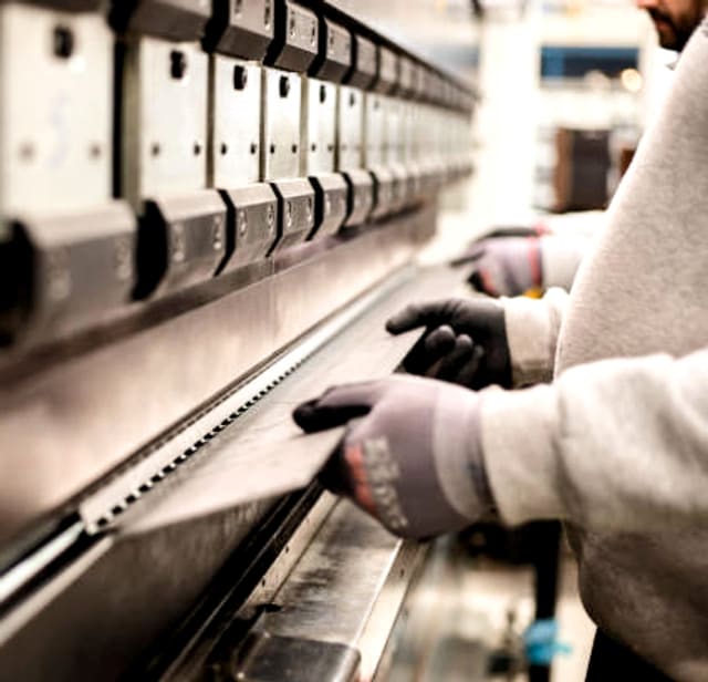 Press brake operator folding a laser cut panel