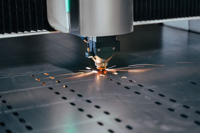 Laser cutting a steel sheet with sparks